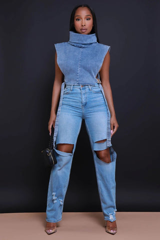 Swank girl wearing ripped flare jeans with a denim top